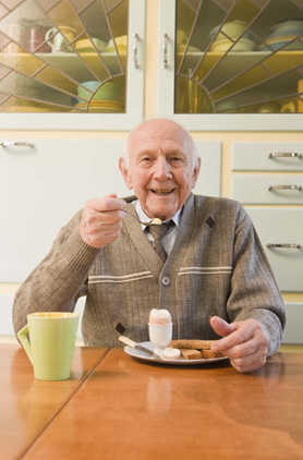Elderly man eating 